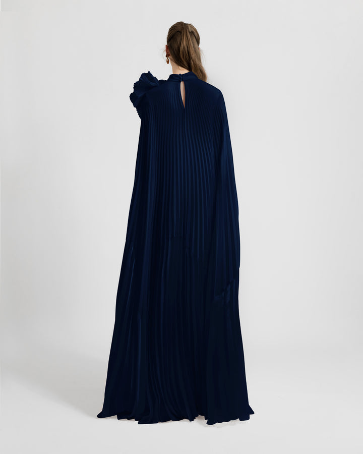 The back of a fully pleated lame organza flared navy kaftan dress.