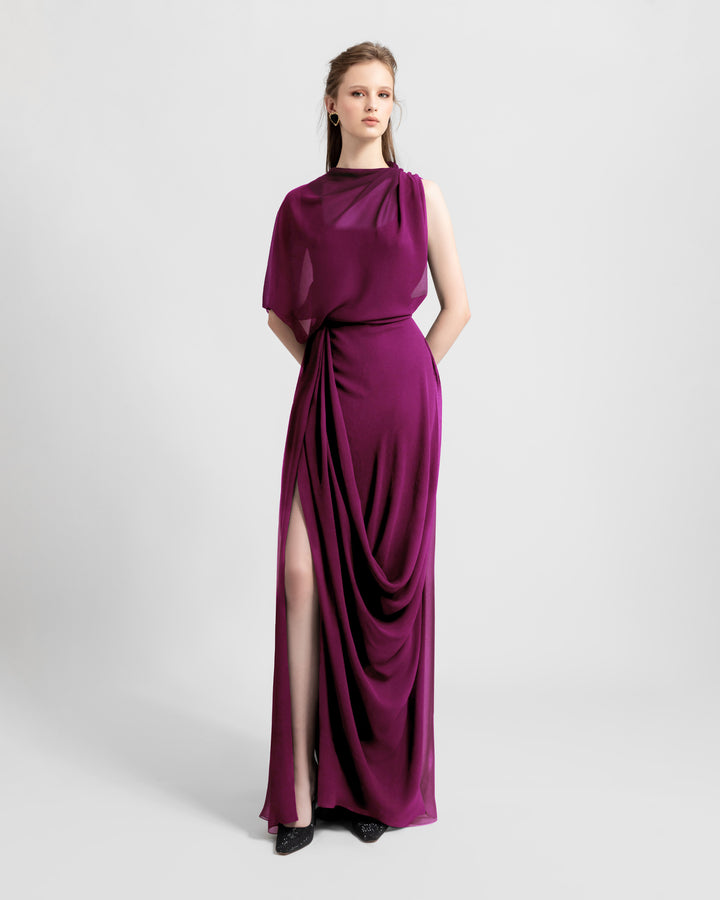 An asymmetrical chiffon evening dress with draping details featuring a slit on the side.