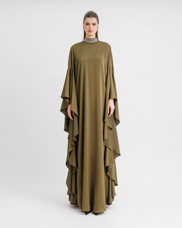 A kaftan-style evening dress in olive green color with a beaded collar and ruffled floor-length sleeves.