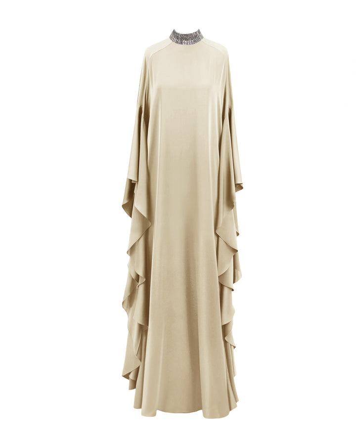 A kaftan-style evening dress in cream color satin with a beaded collar and ruffled floor-length sleeves.