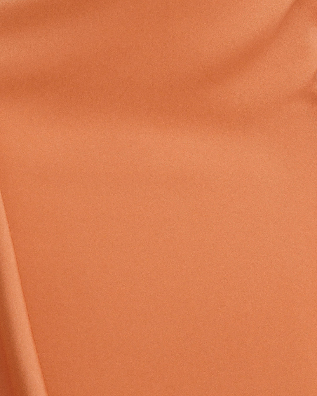 A close-up of a copper satin fabric.