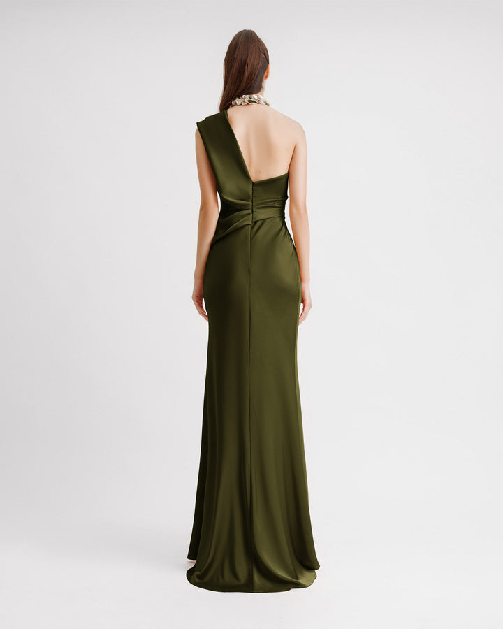 The back of a one-shoulder draped evening satin dress with floral embellishments on the neckline.