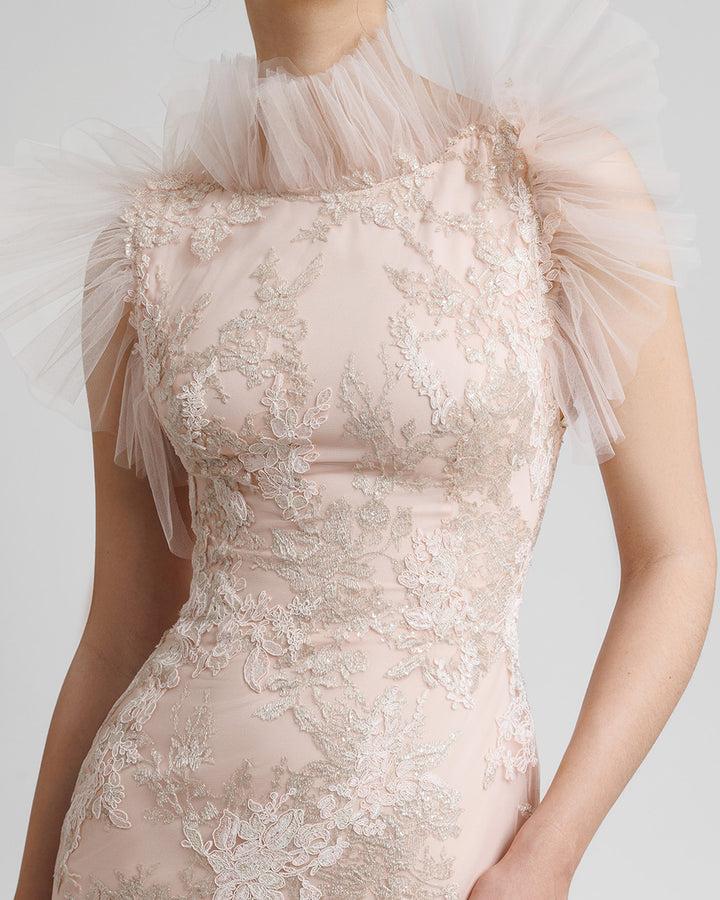 A close-up of a fully embroidered lace long blush evening dress with rushed tulle on the neckline and shoulders line.