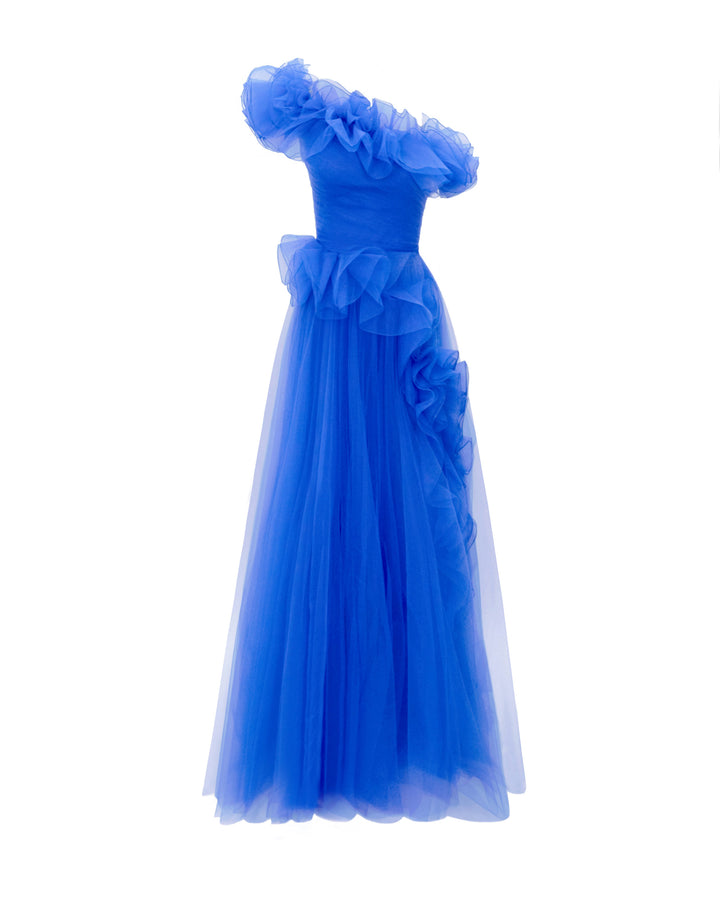 A flared royal blue evening dress featuring an asymmetrical ruffled neckline, and ruffled embellishments on the skirt.