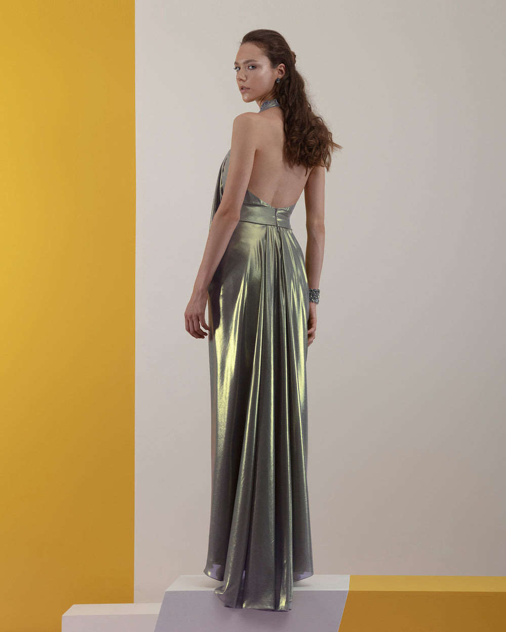 A deep draped details grey laminated chiffon long evening dress with backless design.