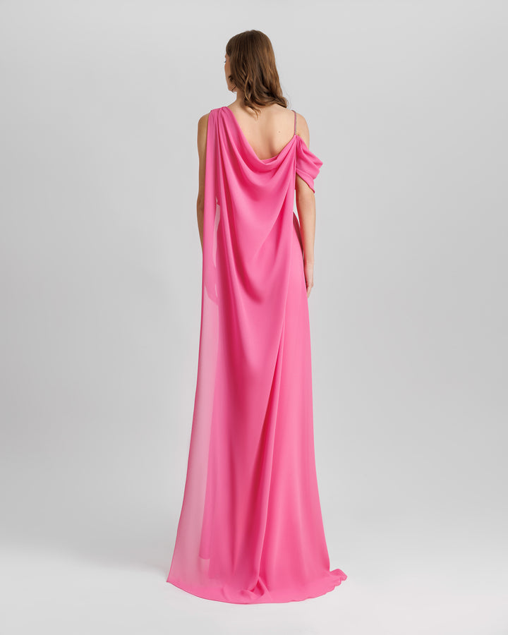 The back of an asymmetrical neckline, one-shoulder draped pink evening dress with a dropped cape at the back.