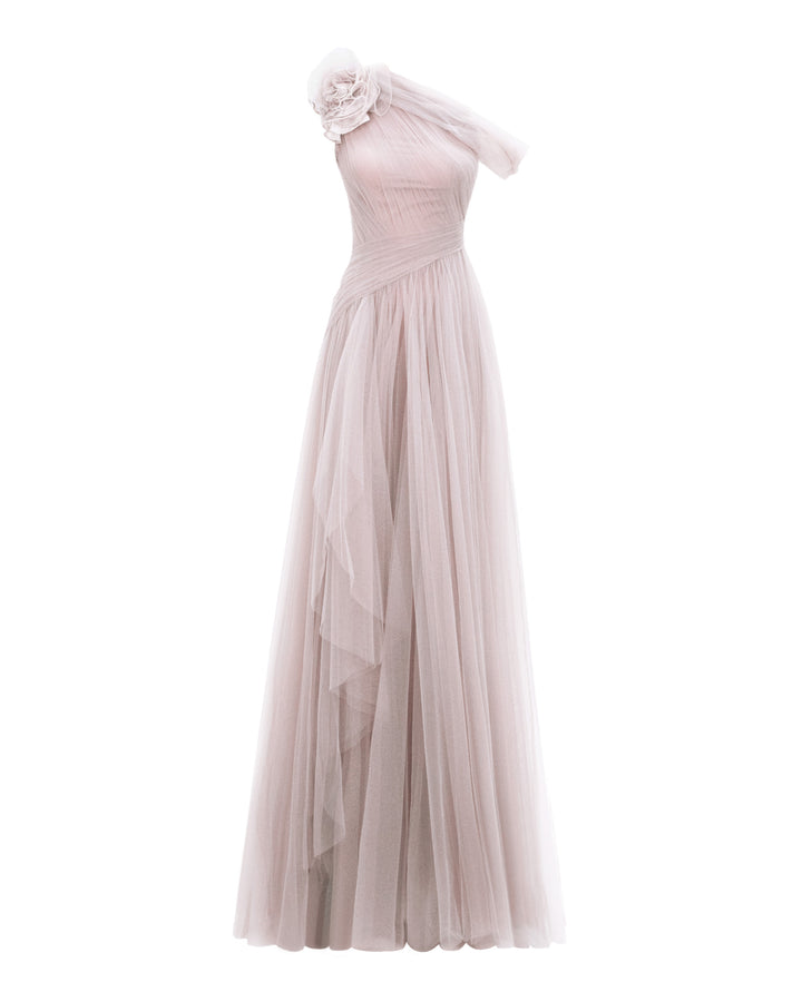 A full tulle long evening dress, with an asymmetrical neckline, a flower design on the shoulder, a ruffled side slit, and draping design on the bodice.