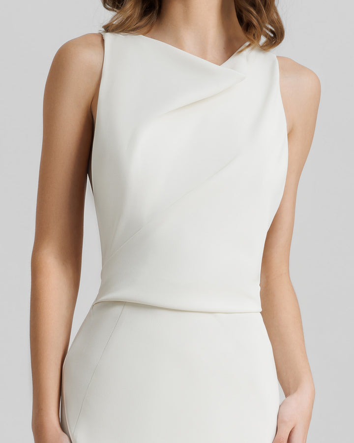 A close-up of a slim-cut cream evening dress features captivating draping on the neckline and waist.