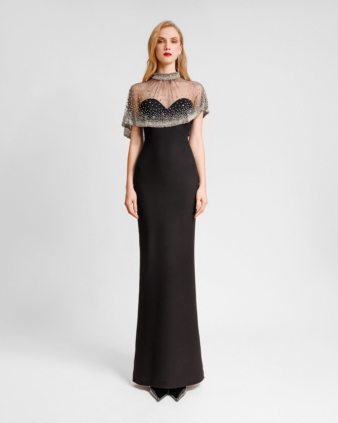 A strapless straight-cut black evening dress with an asymmetrical beaded tulle overlay.