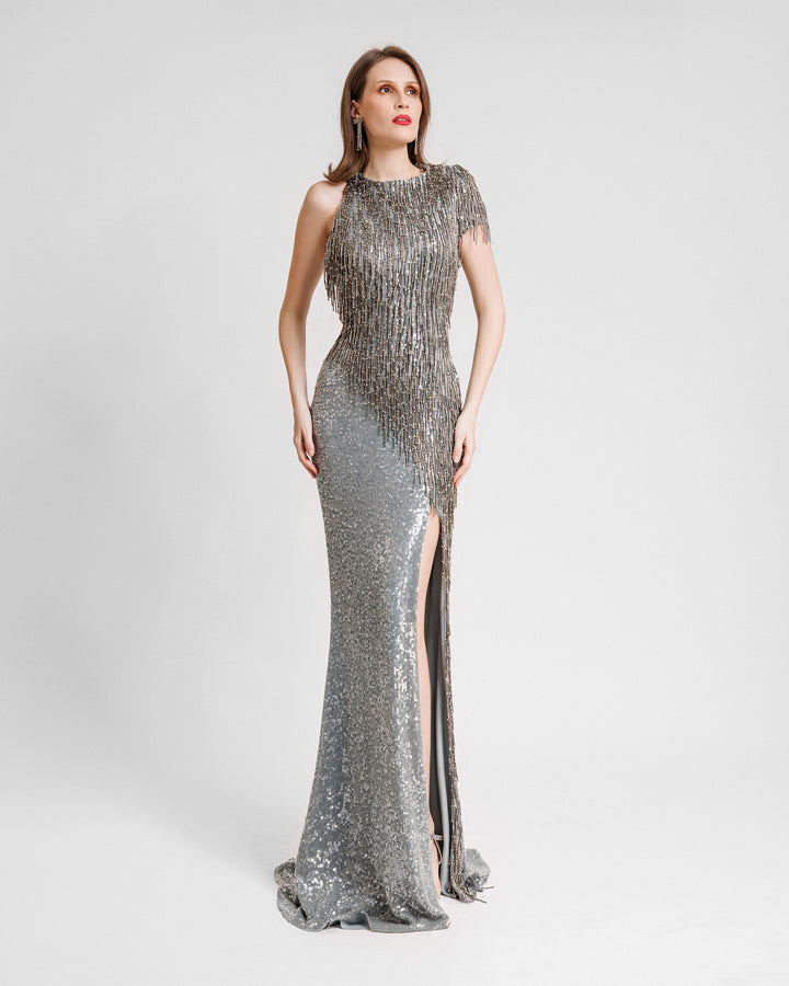 A single short sleeve evening dress featuring beaded tassels on the upper part  and a slit on the side.