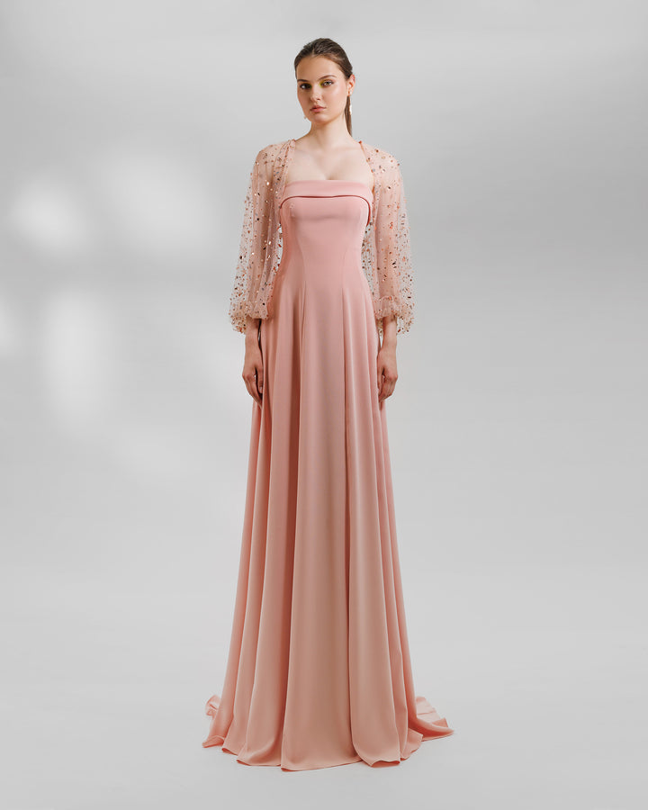 A strapless flared long peach crepe evening dress, featuring a folded strap. Over it a fully beaded tulle Bolero.