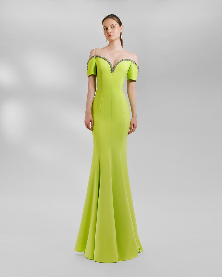 A lime long evening dress with a sweetheart beaded neckline that is off the shoulders. This design is featuring a mermaid cut.