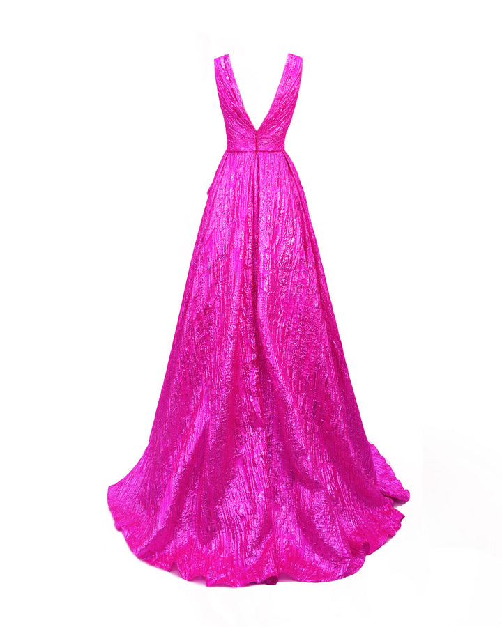 The back of a v-shaped back fuchsia evening dress featuring a wide draped tail.