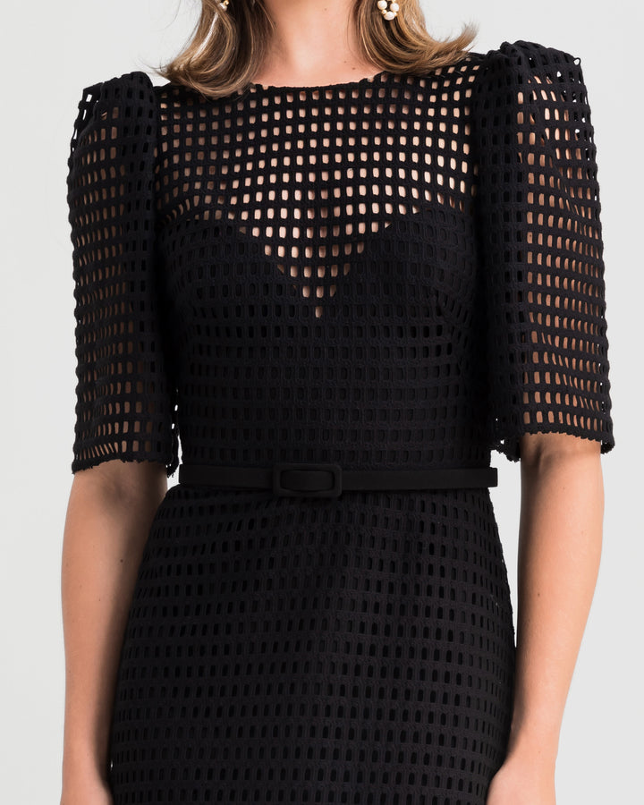 A close-up of a crochet lace flared midi dress with puffed sleeves and a detachable belt.