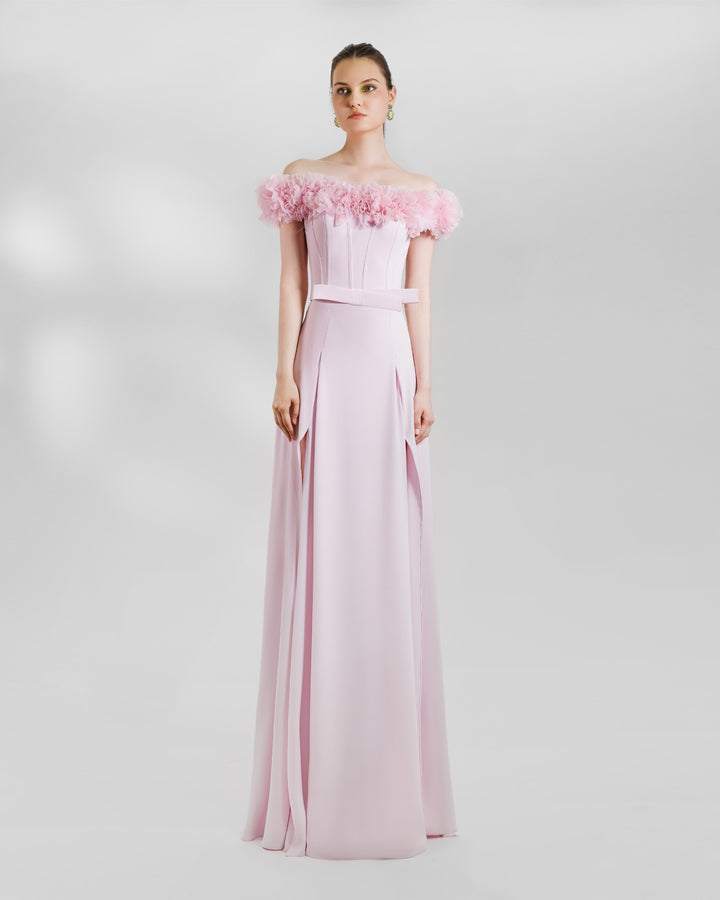 A pink occasion wear featuring an off-the-shoulders corset top with rushed details on the neckline paired with a long skirt with openings on the sides.