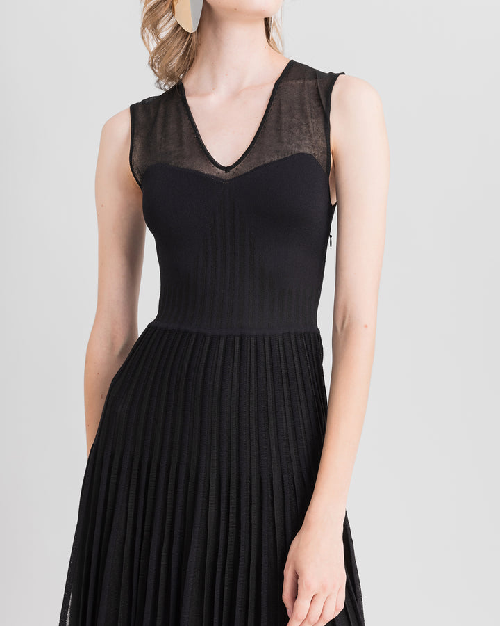 A close-up of a V-neckline with heart shape design black knit midi dress.