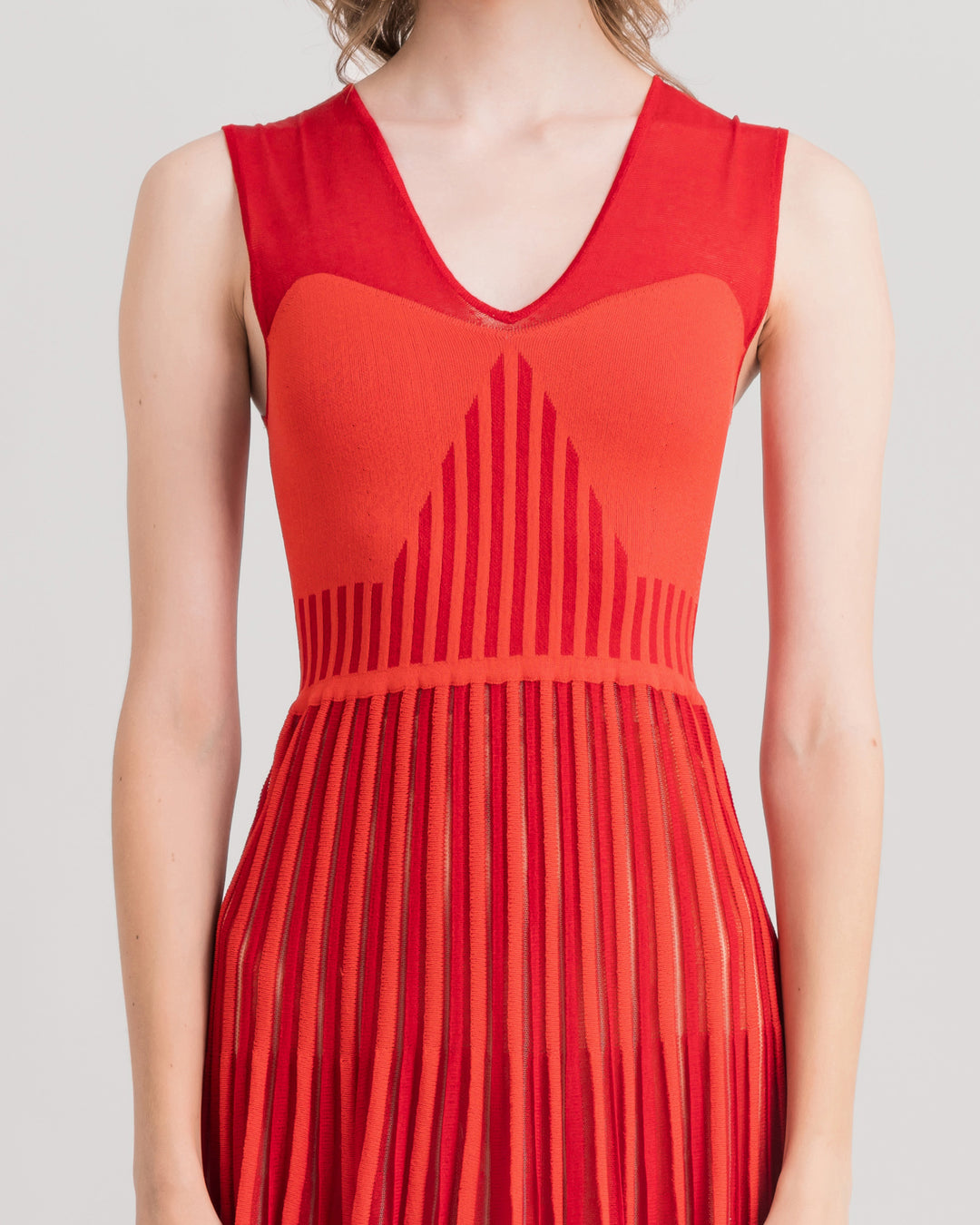 A close-up of a v-neckline with heart shape design midi knit red dress.