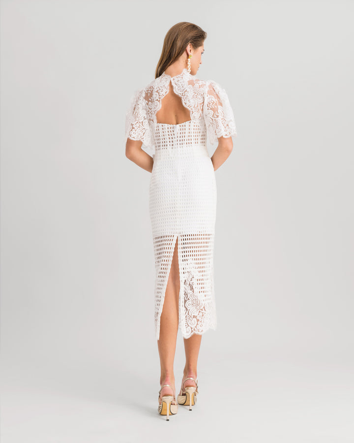 A white midi dress featuring a high-collar lace top with flared sleeves and an open back, paired with a midi lace pencil skirt.