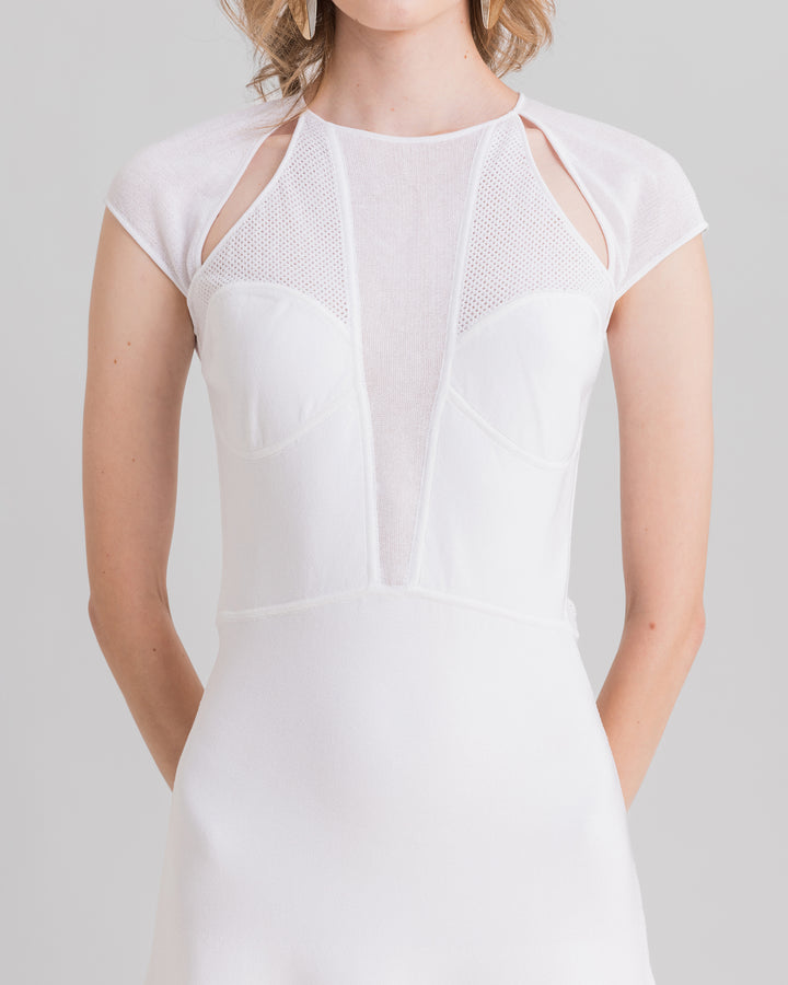 A close-up of a white midi knit dress featuring cut-outs on the shoulders and a deep v-neckline.