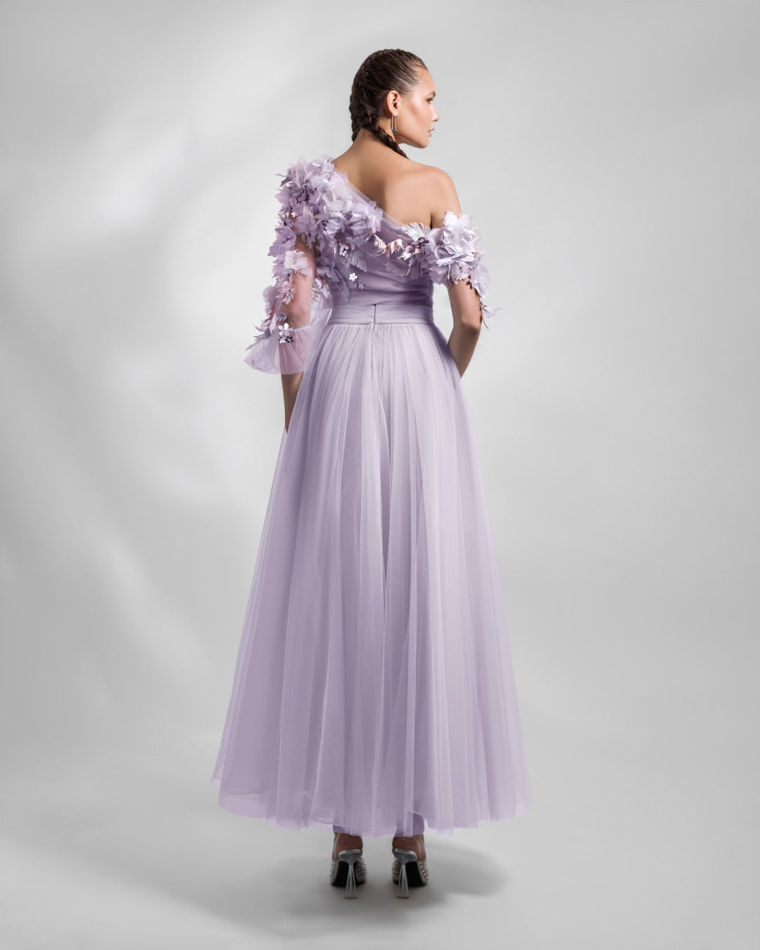 The back of a one-shoulder dusty lilac tulle dress with an embellished bodice and a draped waist.