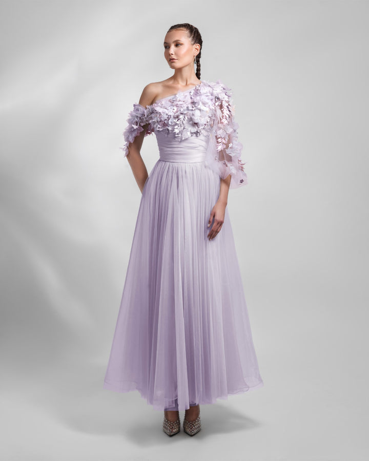 A one-shoulder dusty lilac tulle dress with an embellished bodice and a draped waist.