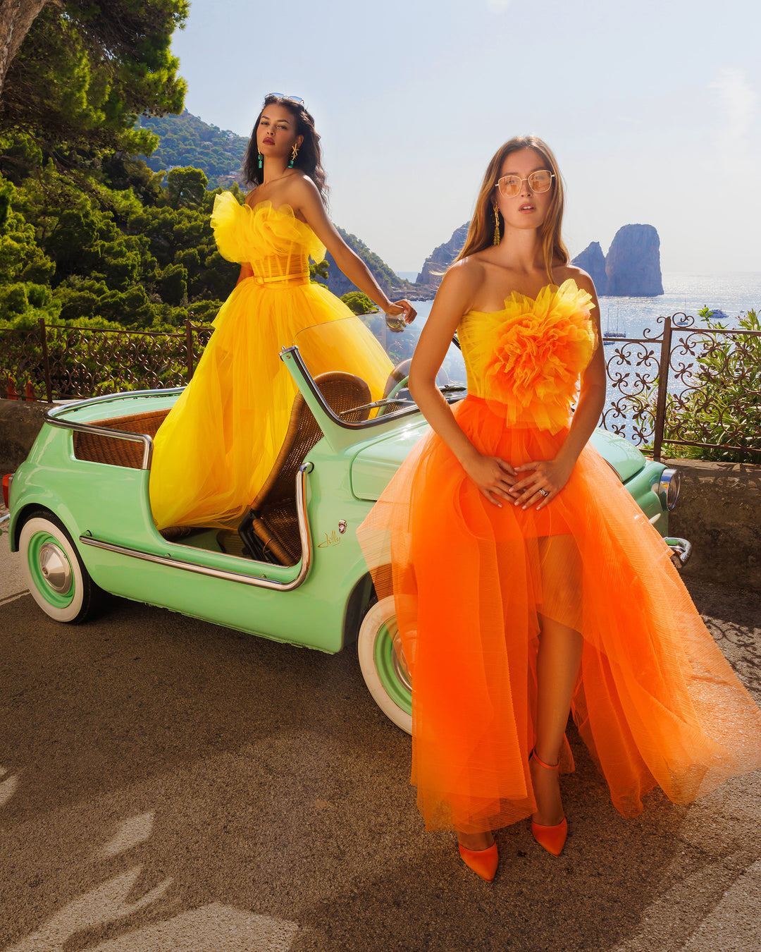 A flower draped tulle long dress with an orange fully pleated long skirt.