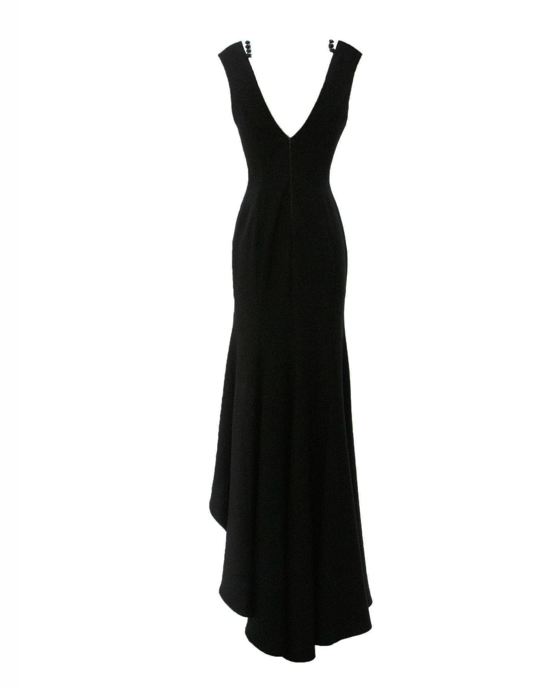 The back of a slim cut black evening dress with a V-shape open back and an asymmetrical ruffled hemline in crepe fabric.