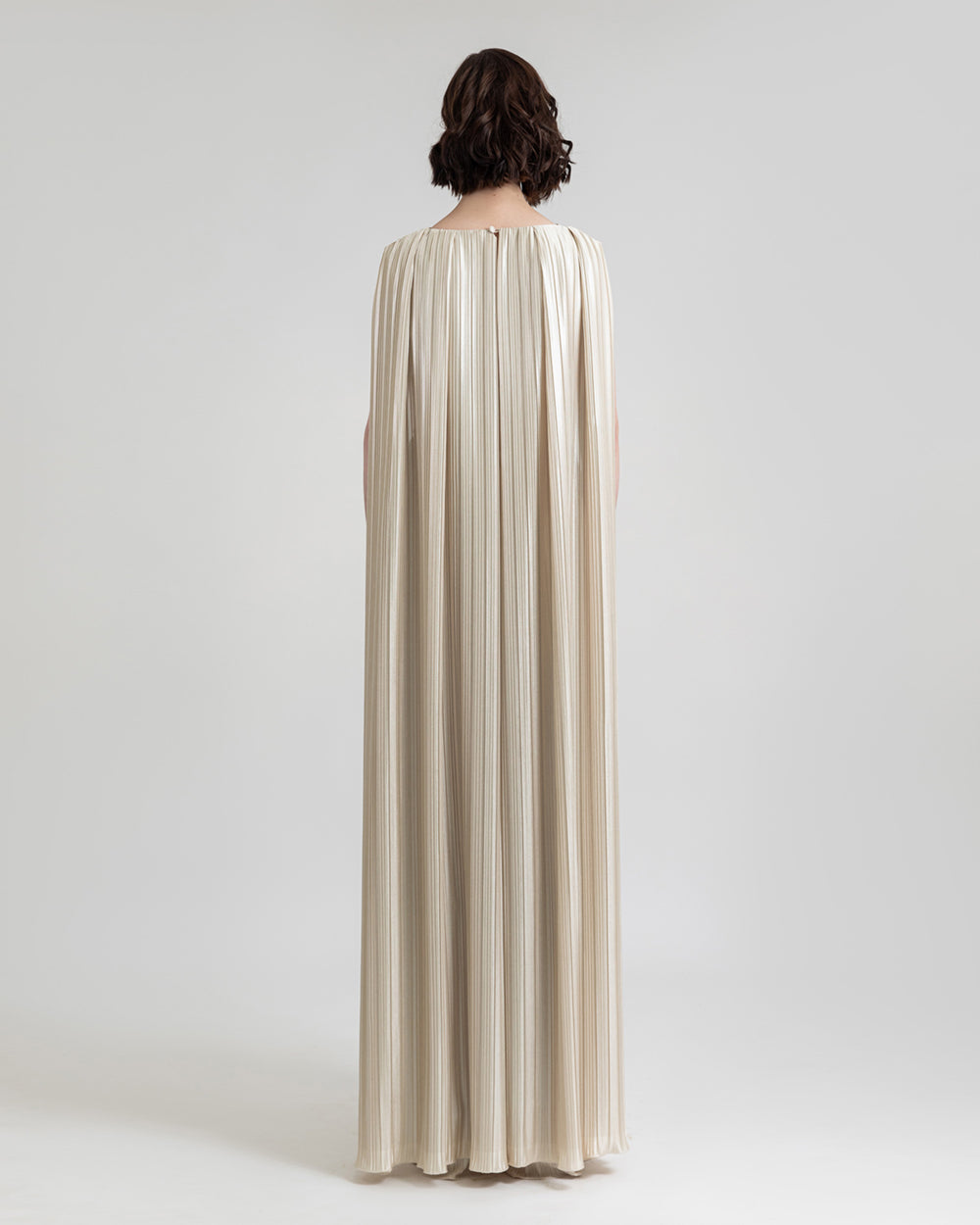 A cape-like back design champagne jumpsuit.