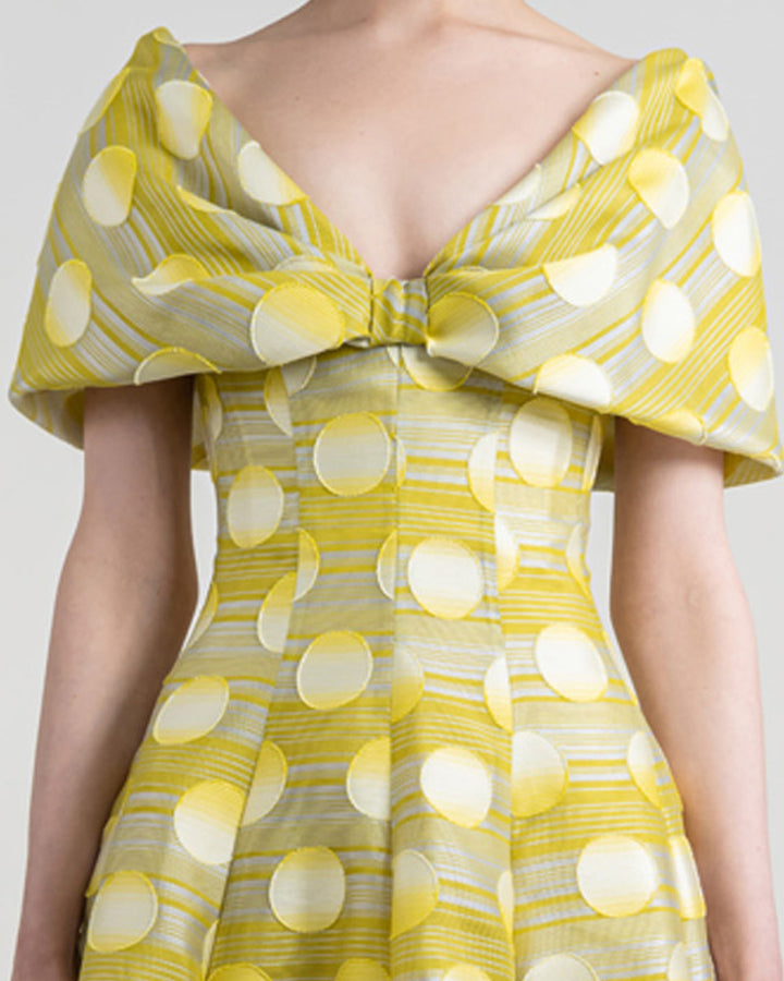 A close up of a bow-like upper part flared yellow evening dress.