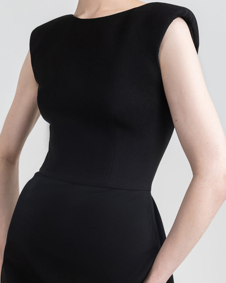 A close-up of a slim cut black evening dress.