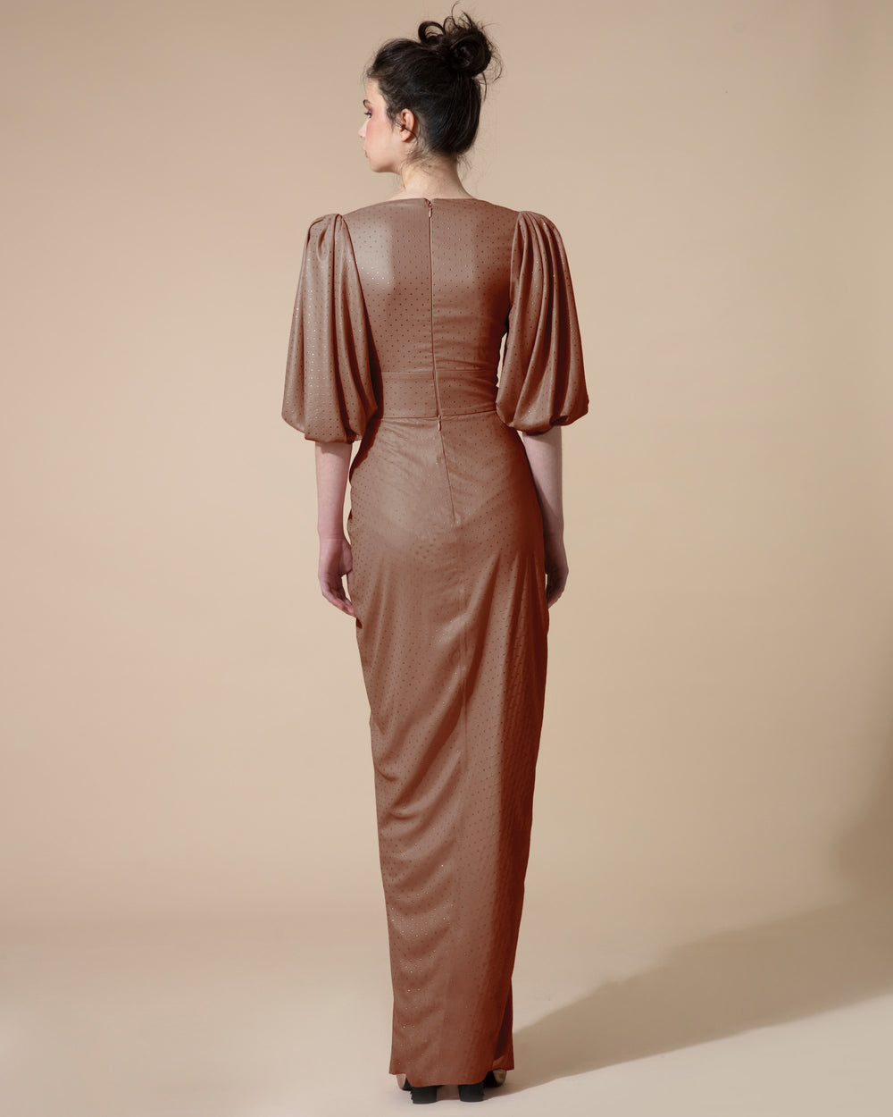 The back of a long brown evening dress with short bishop sleeves.