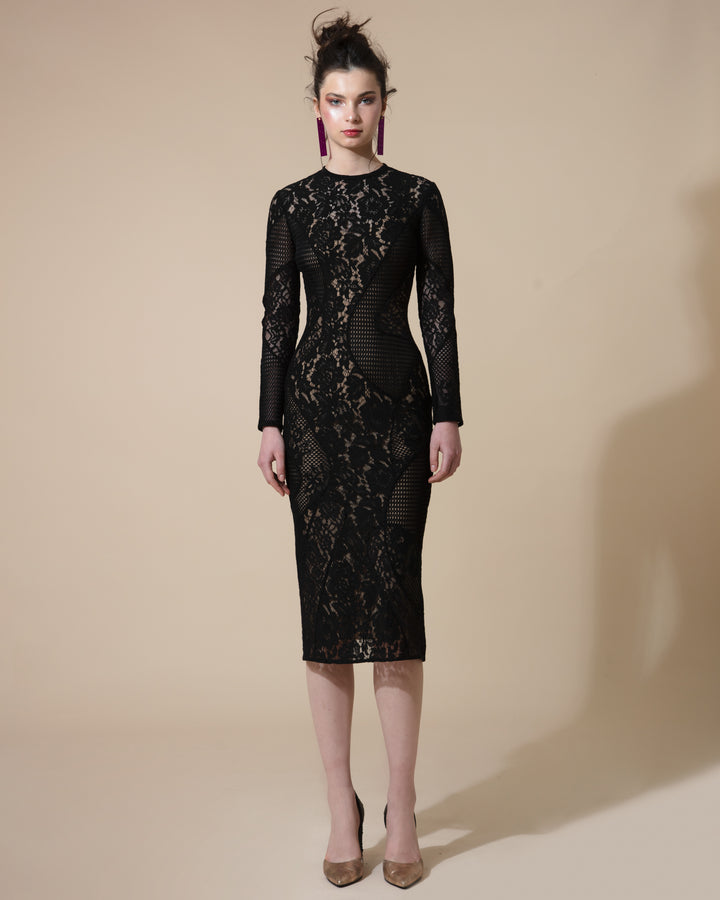 A fully lined lace black dress with asymmetrical cuts, long sleeves and a rounded neckline.