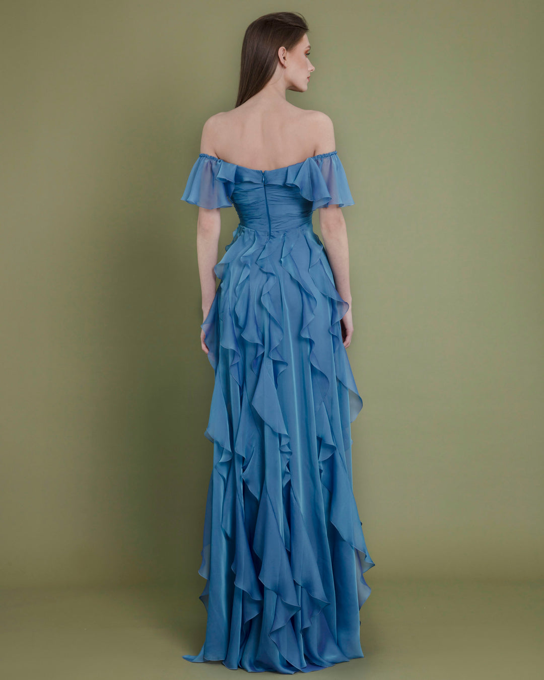 The back of a flared cut off-shoulders blue evening dress featuring fully ruffled details.