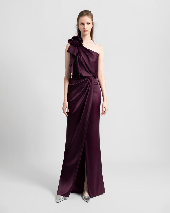 A one-shoulder satin dress with draping details and open slit in the middle.