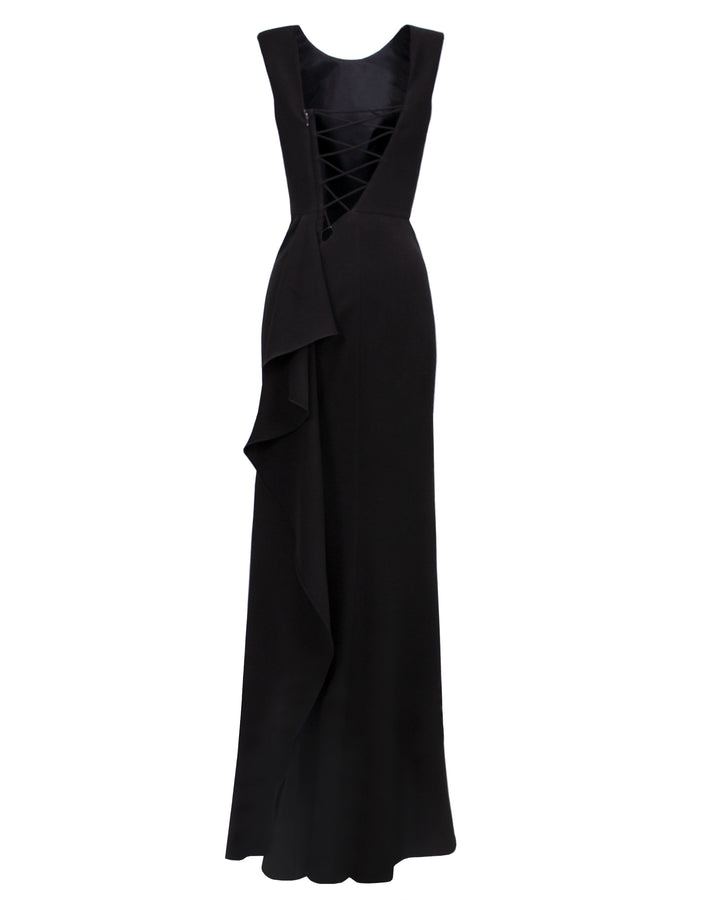 A slim cut black evening dress with a lace-up backless design and ruffles details on a side slit.