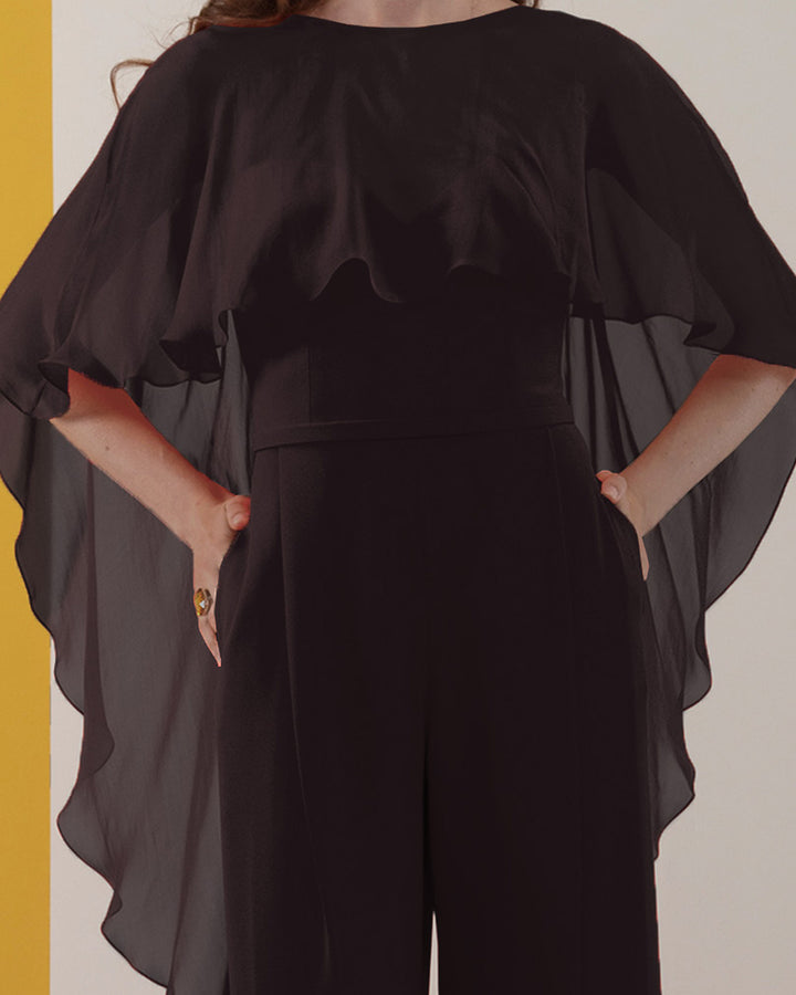 A black jumpsuit with ruffled flowy chiffon cape-like neckline.