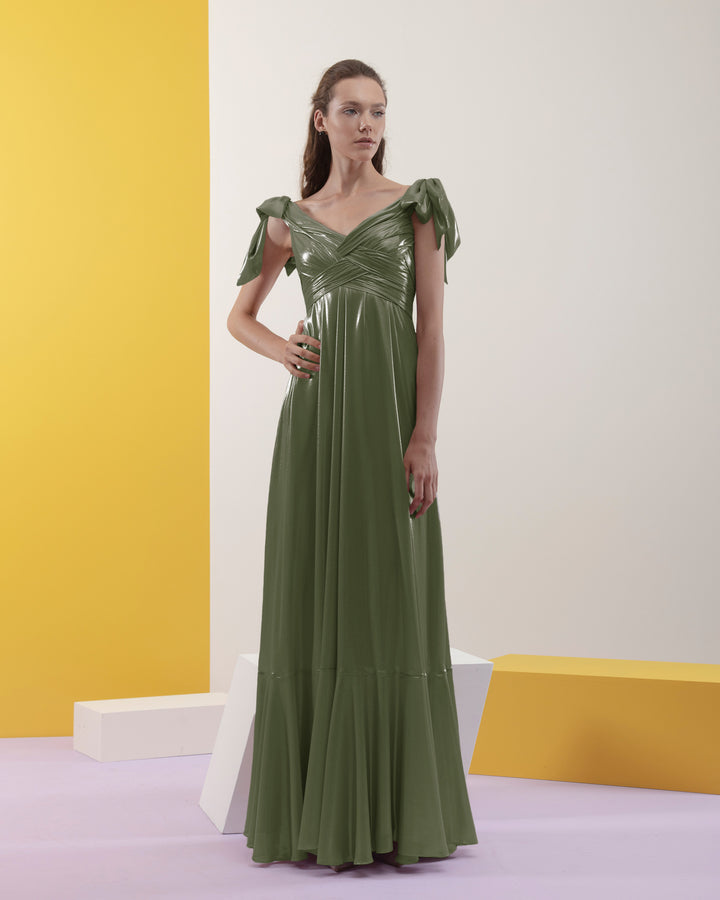 A draped upper part flared cut, laminated green chiffon long dress with bow-design details on the shoulders.