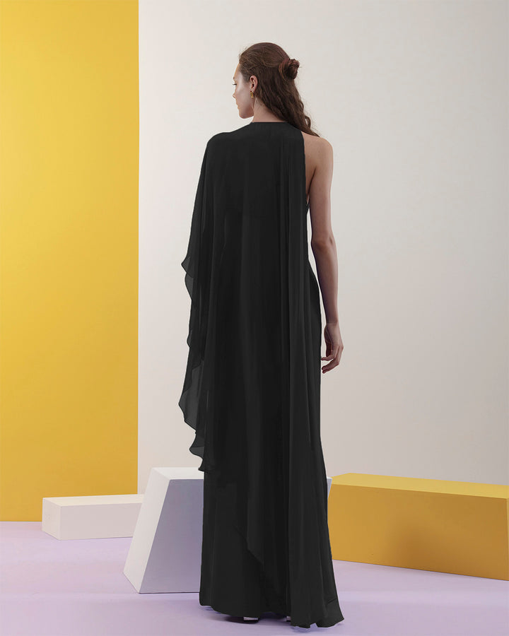 The back of a rounded neckline, slim cut crepe black dress with one sided draped flowy chiffon fabric.