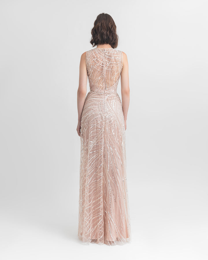 The back of a long pink evening dress with a open back overlayed with sequin fabric.