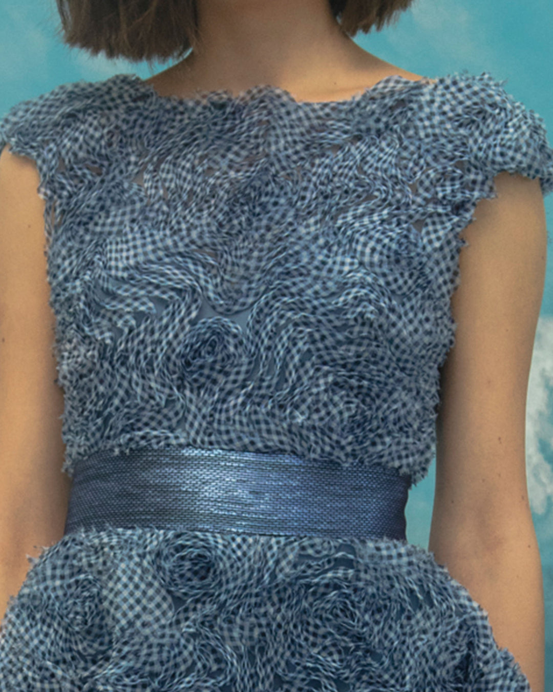 A close-up of a midi blue dress in a fluffy textured chiffon.