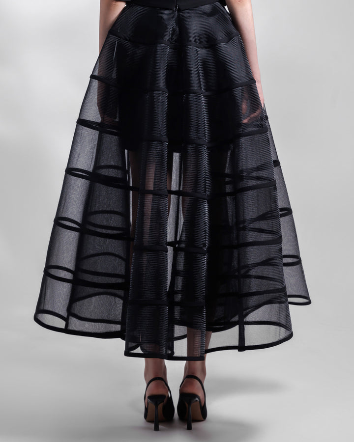 The back of a long cage-like black skirt.