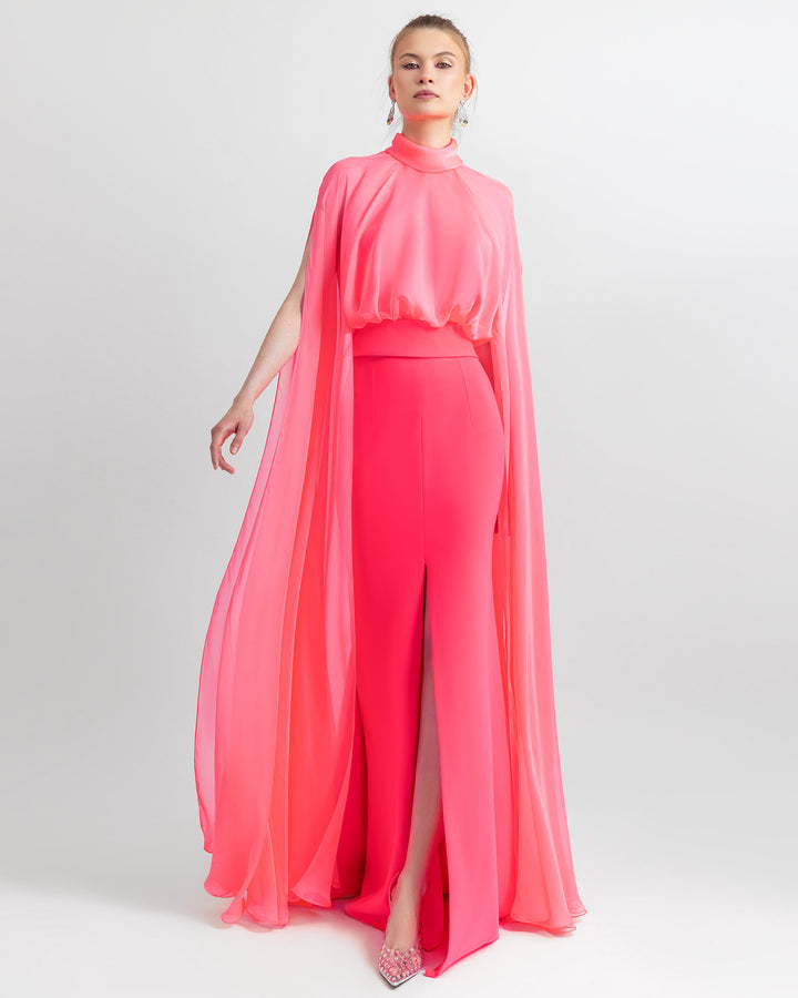 An elegant outfit featuring a high-neckline pink top with long sleeves, paired with a mermaid cut skirt.