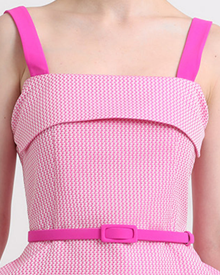 A close-up of an asymmetrical two tone pink top with detachable belt.