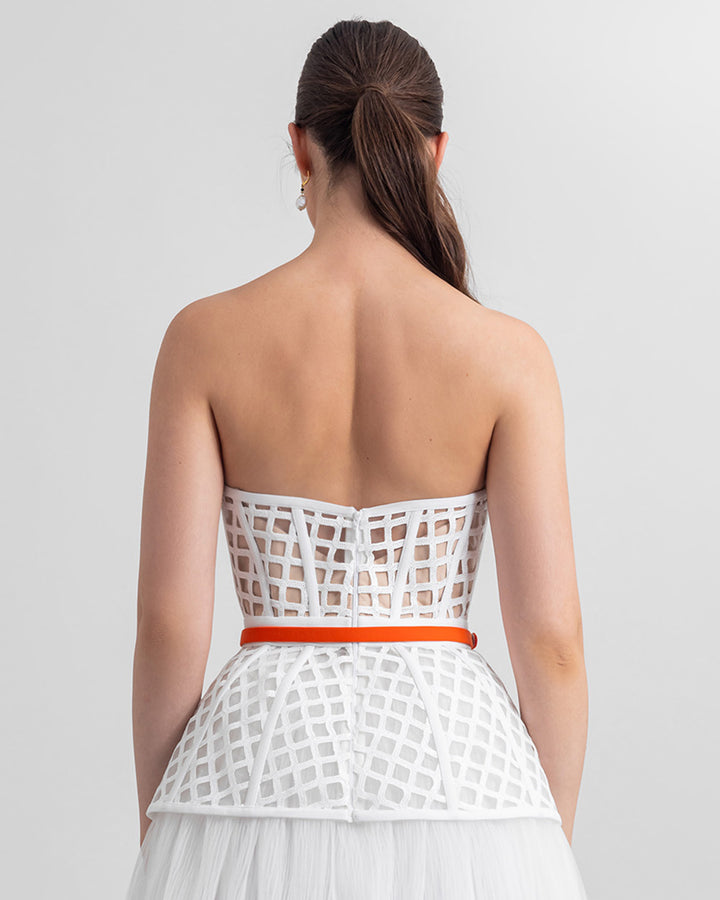 The back of a strapless corset-like top with a detachable orange belt.