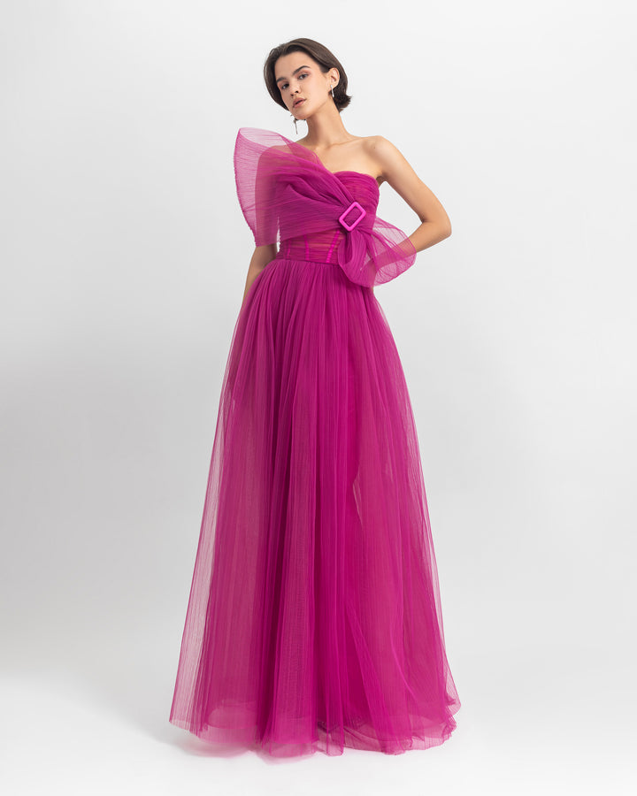 An evening wear set featuring a bow-like strapless corset top paired with a fully-pleated tulle long fuchsia skirt.