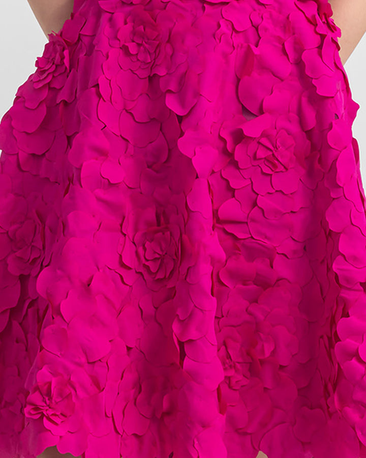 A close-up of a laser cut short A-line fuchsia skirt.