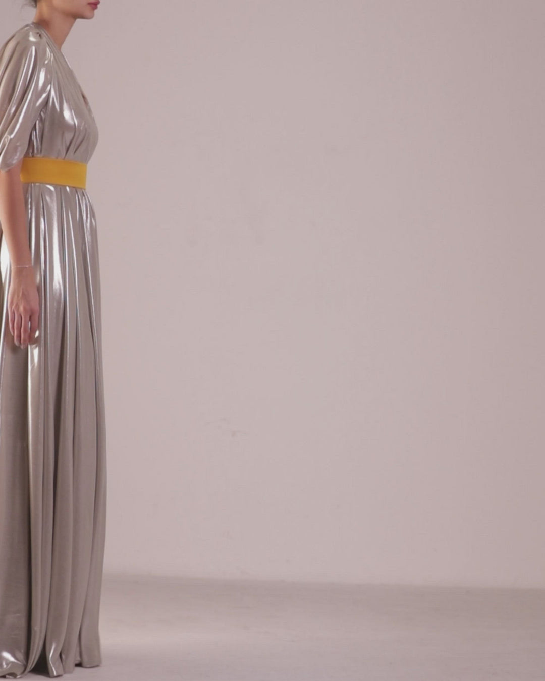 A deep V-neckline, loose cut laminated silver chiffon dress with backless design paired with a detachable yellow belt.