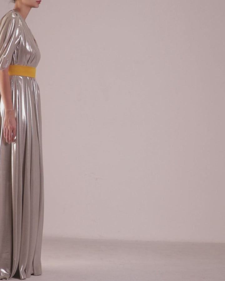 A deep V-neckline, loose cut laminated silver chiffon dress with backless design paired with a detachable yellow belt.